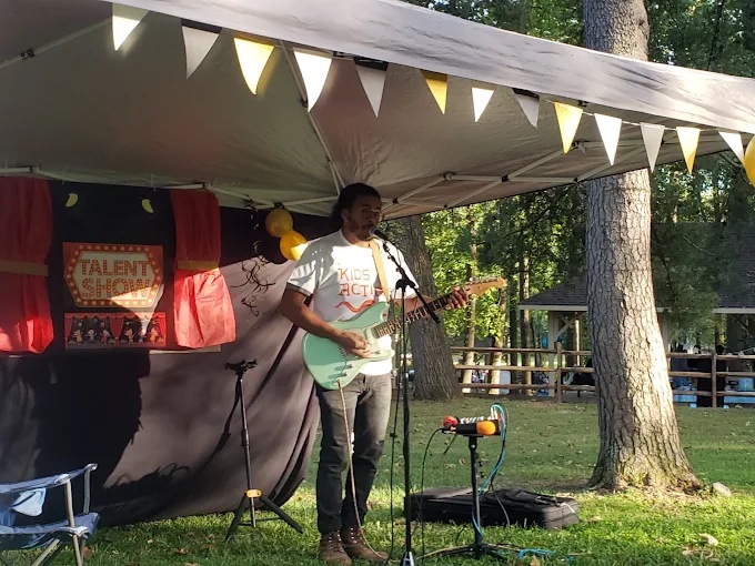 A musician performing at a community talent event